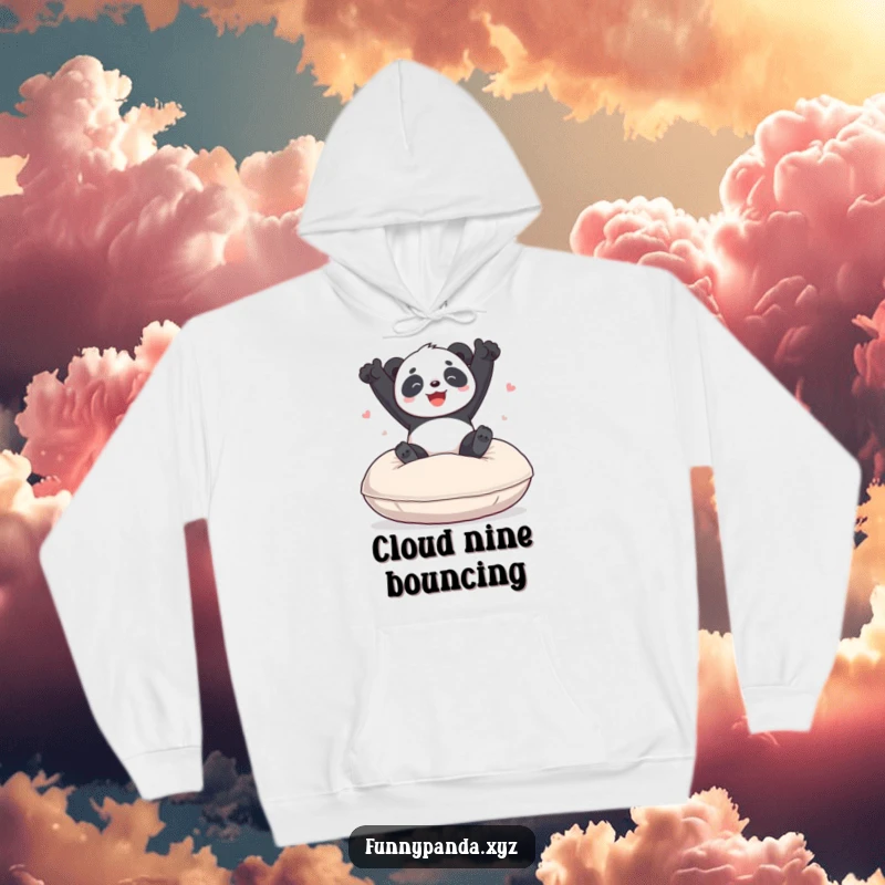 Funny panda hoodie showing a happy, playful panda mid-bounce on a giant soft cushion, perfect for cozying up with a smile.