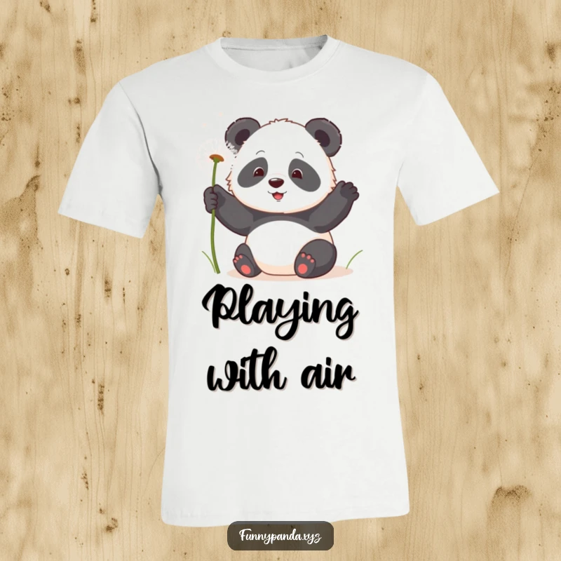 Delightful kawaii panda playfully swatting at floating, fluffy dandelion seeds, printed on a funny graphic tee.